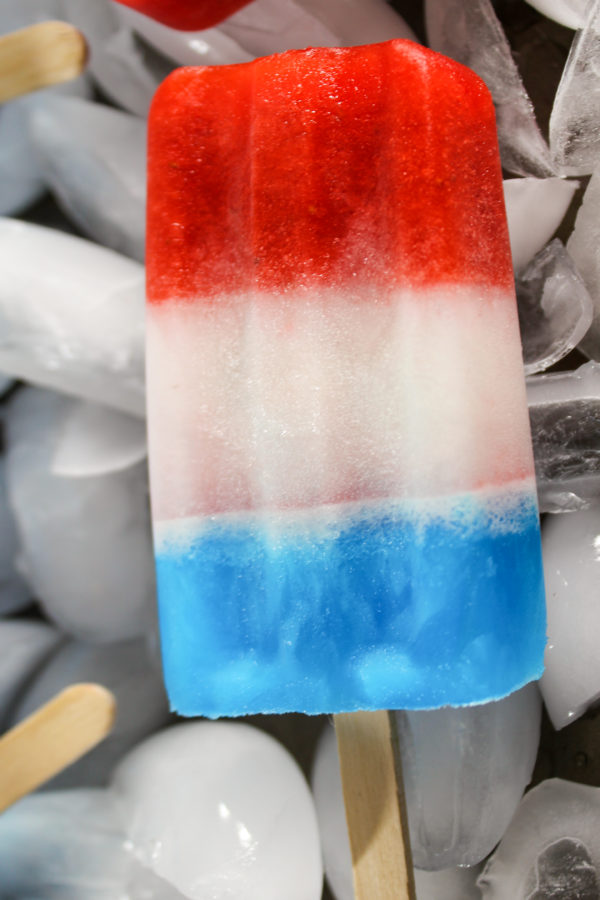 Red, White, and Blue Patriotic Popsicle on a background of ice cubes